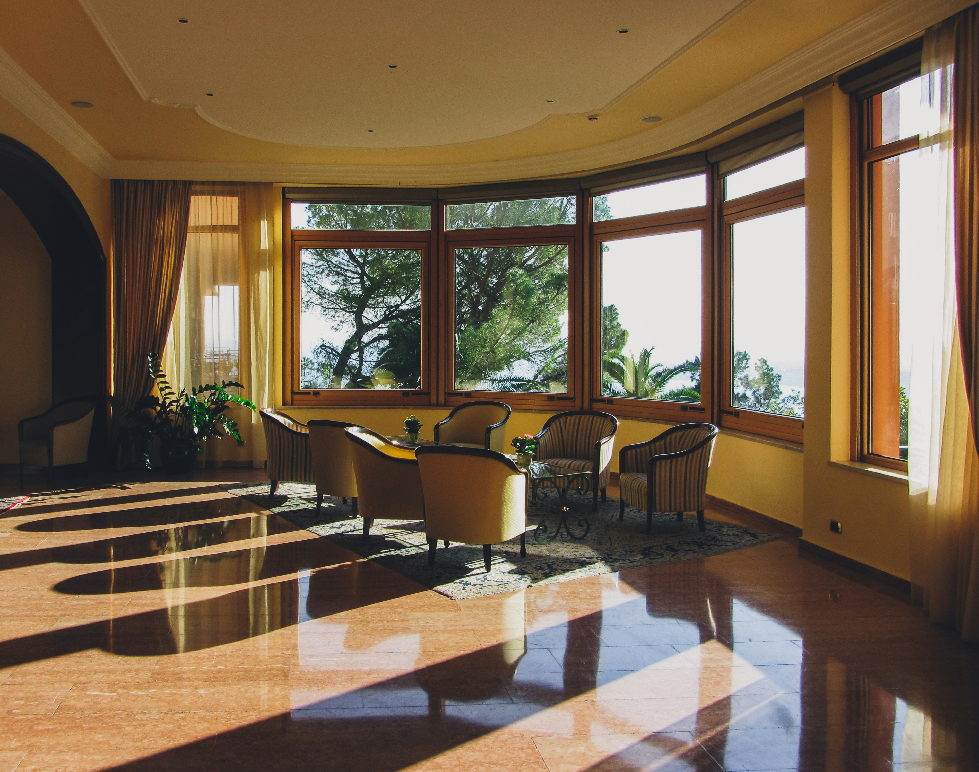 a large room with a lot of windows and chairs