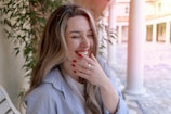 a woman sitting on a bench with her eyes closed