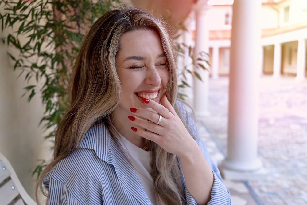 a woman sitting on a bench with her eyes closed