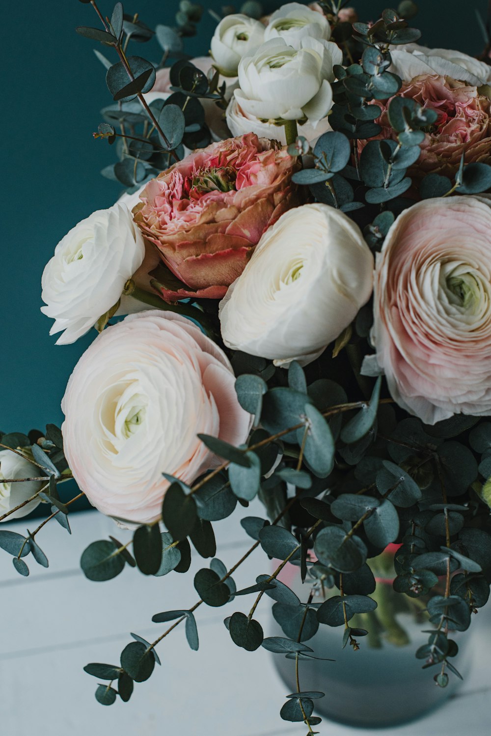 a vase filled with lots of white and pink flowers