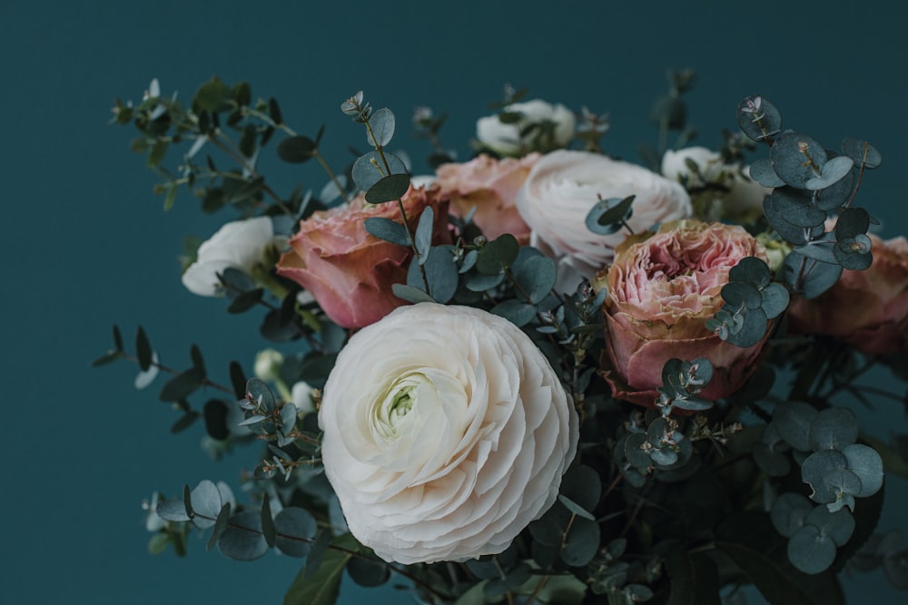 a bouquet of white and pink flowers in a vase