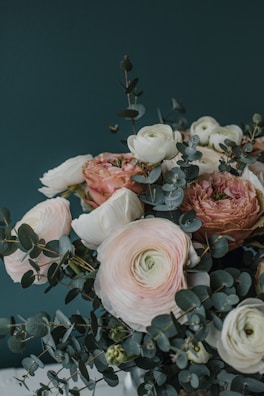 A delicate bridal bouquet of blush roses and eucalyptus, tied with a soft sage ribbon.