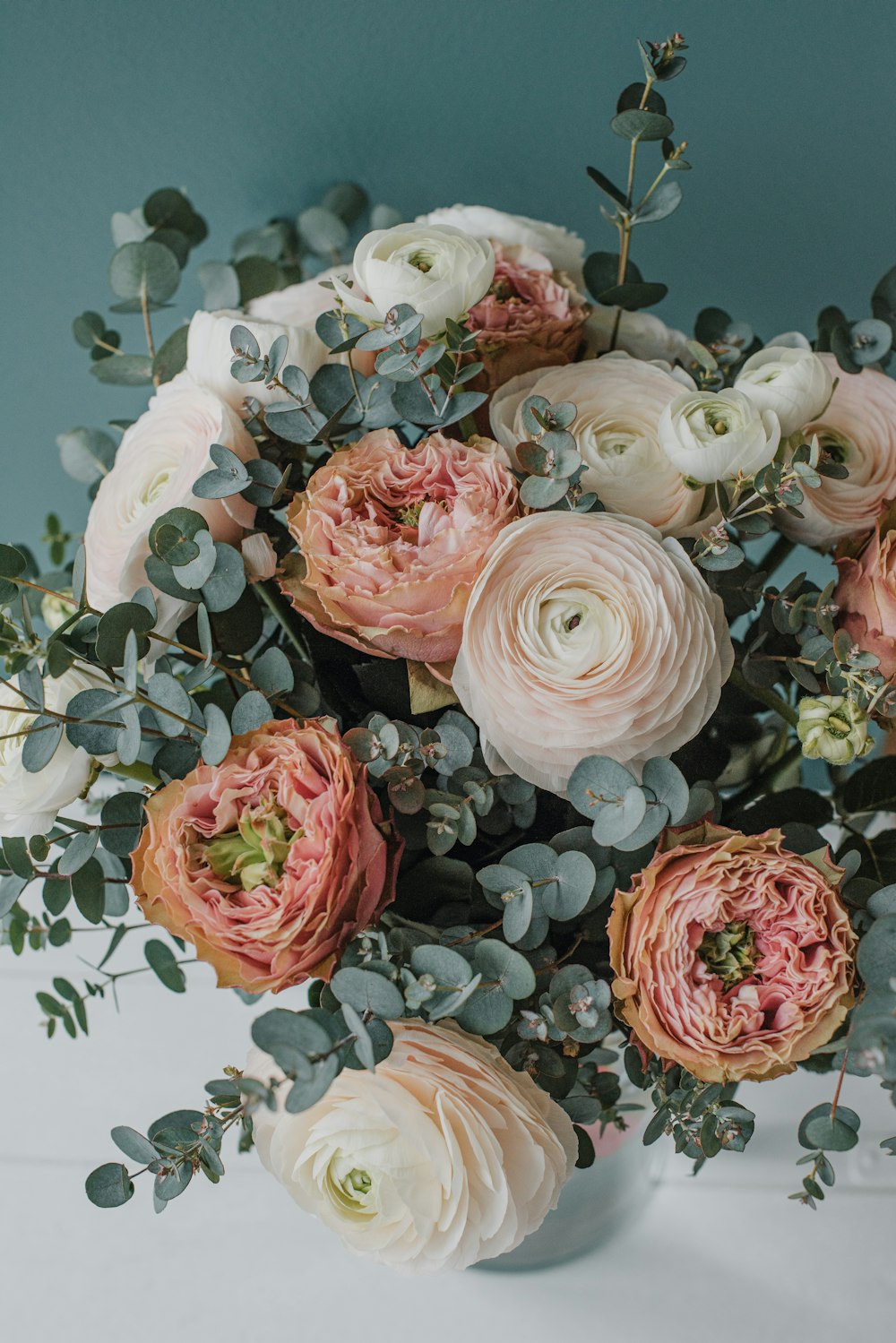 a bouquet of pink and white flowers on a table