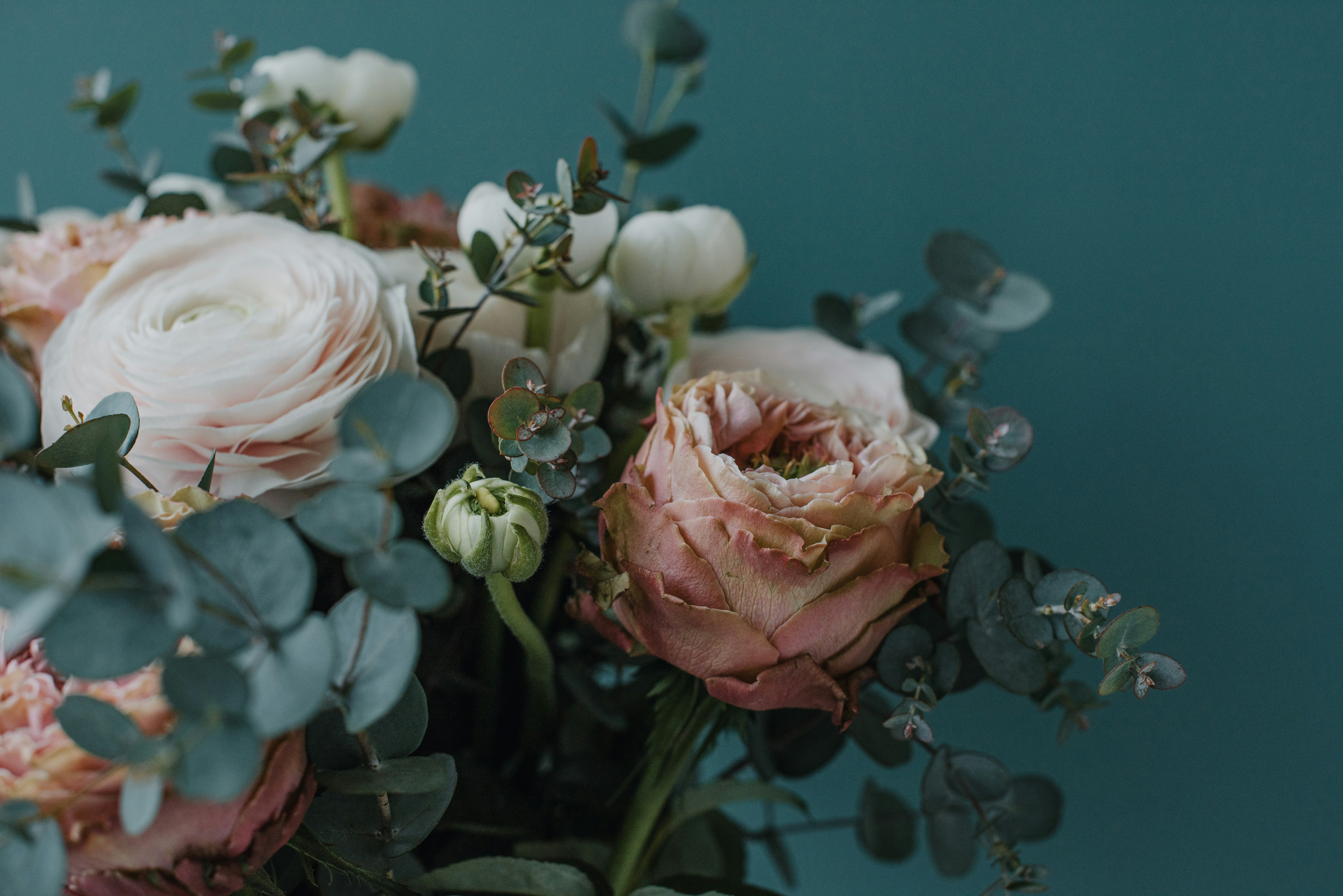 a vase filled with lots of pink and white flowers