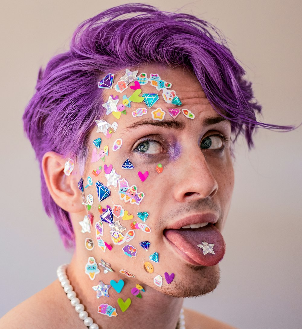 a man with purple hair and face paint