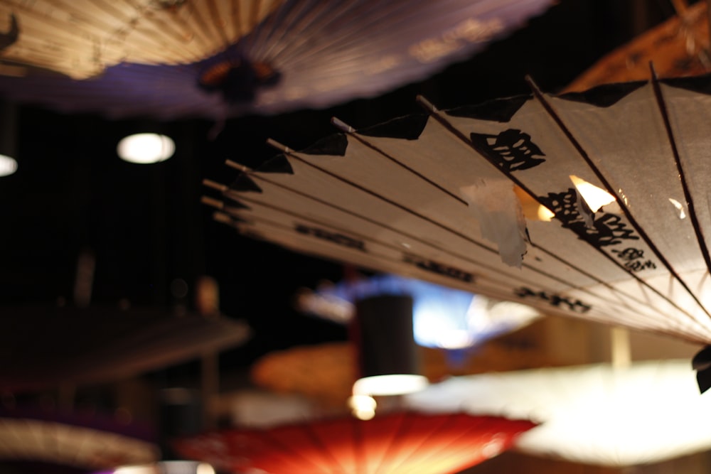 a bunch of umbrellas that are hanging from a ceiling