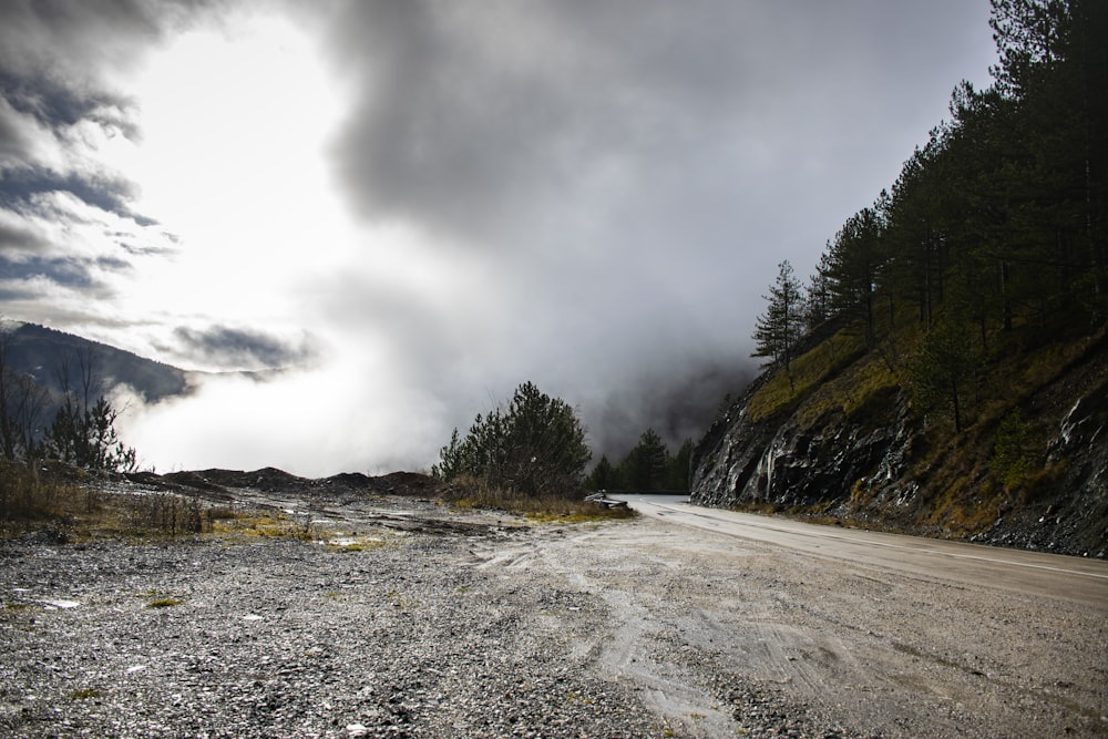 a dirt road with a mountain in the background