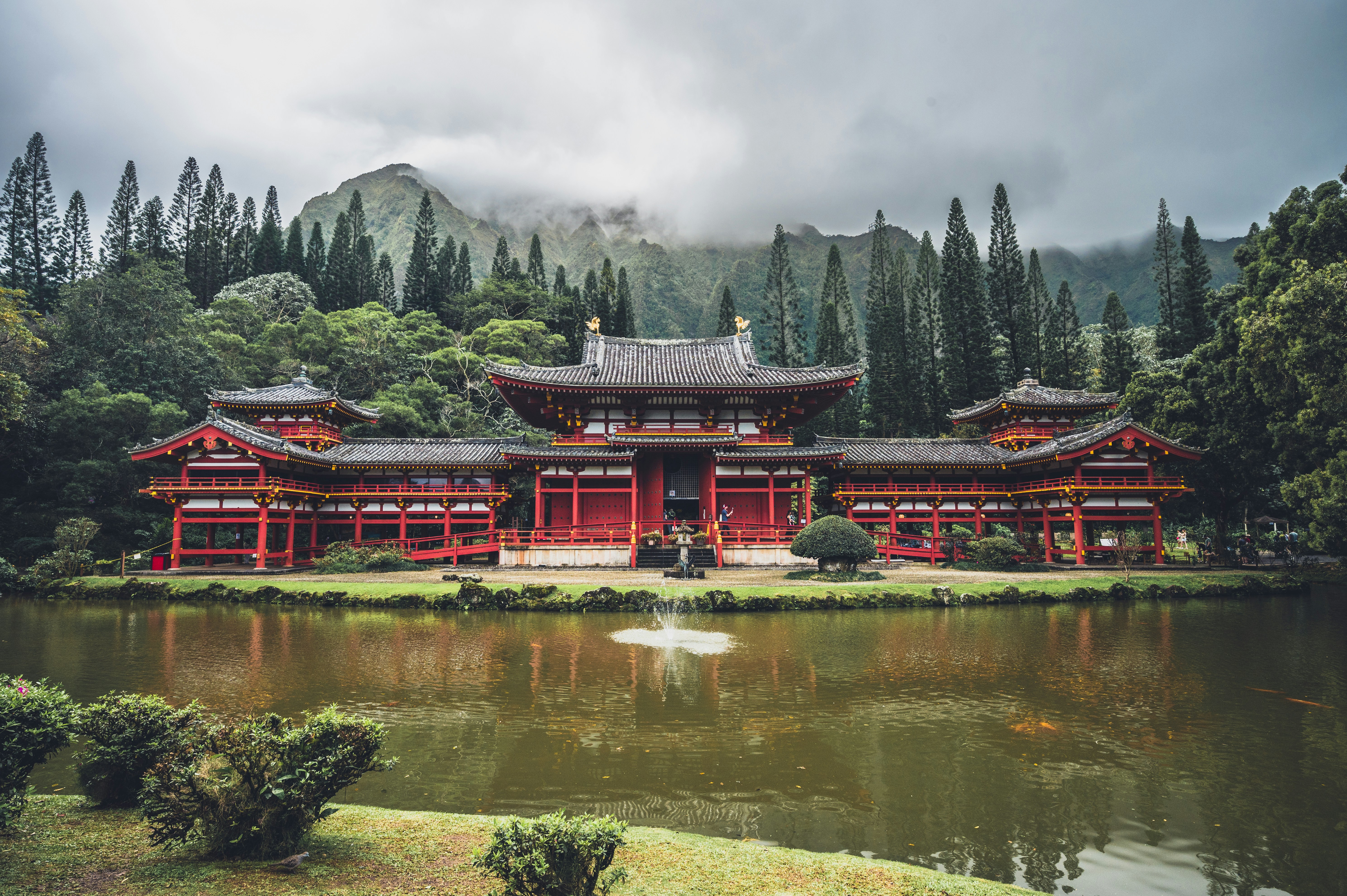 a large red building sitting next to a body of water