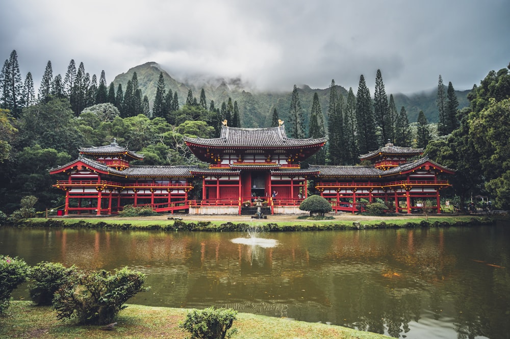 a large red building sitting next to a body of water