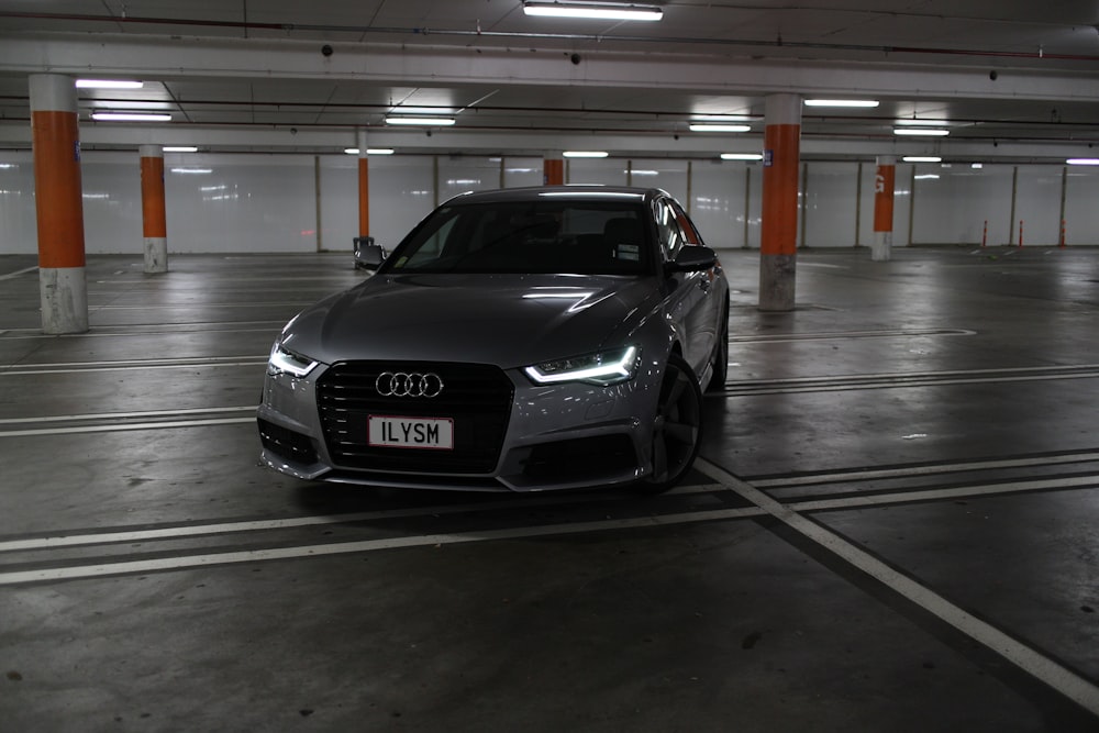 a grey car parked in a parking garage