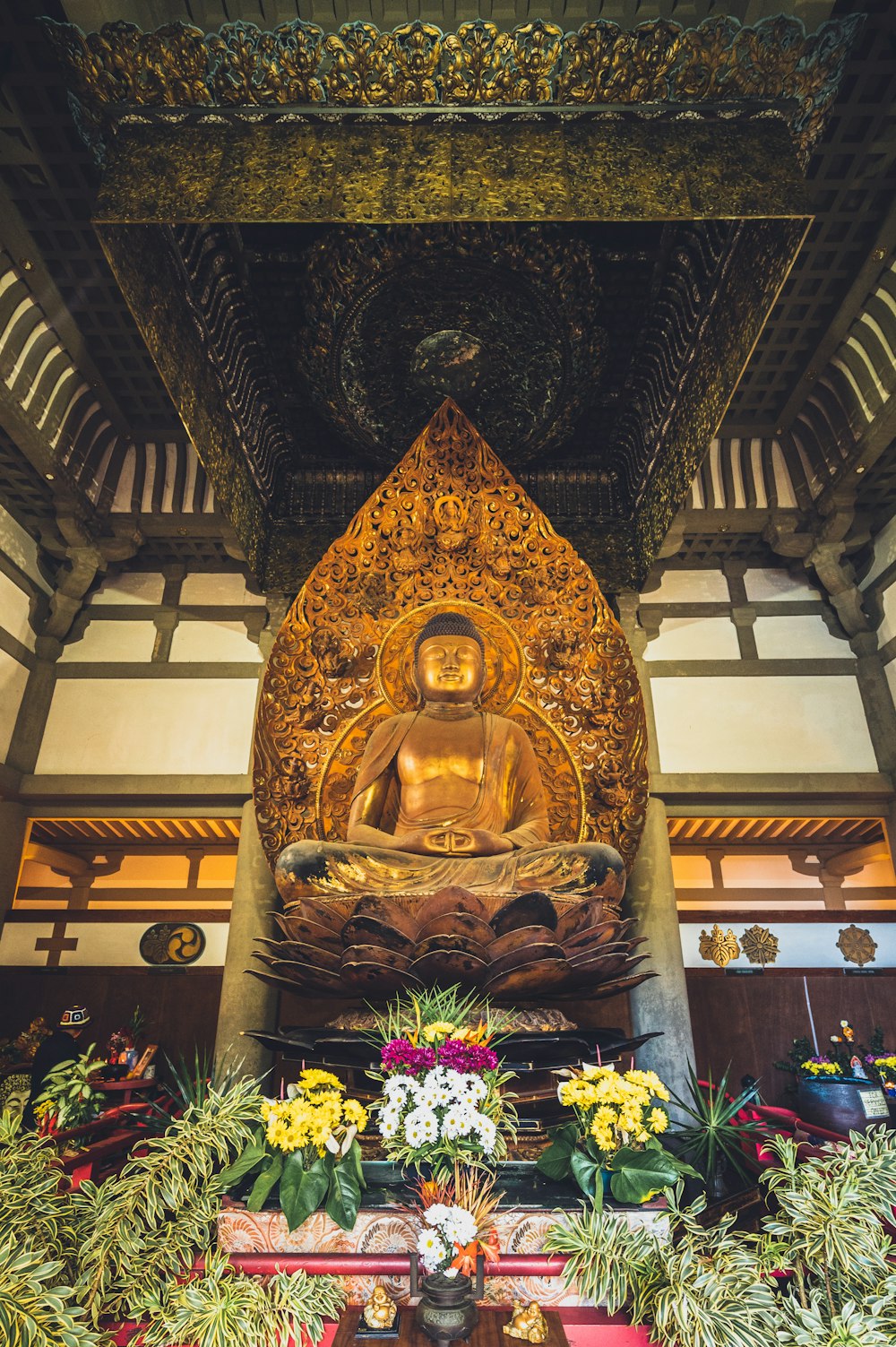 a buddha statue sitting in the middle of a room