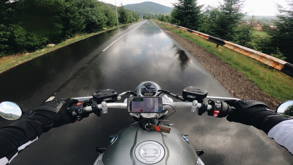 a person riding a motorcycle down a wet road