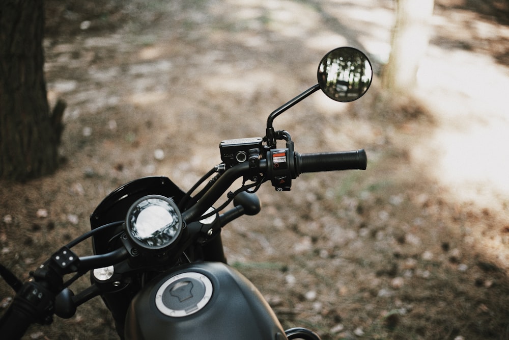 a close up of a motorcycle parked in the woods