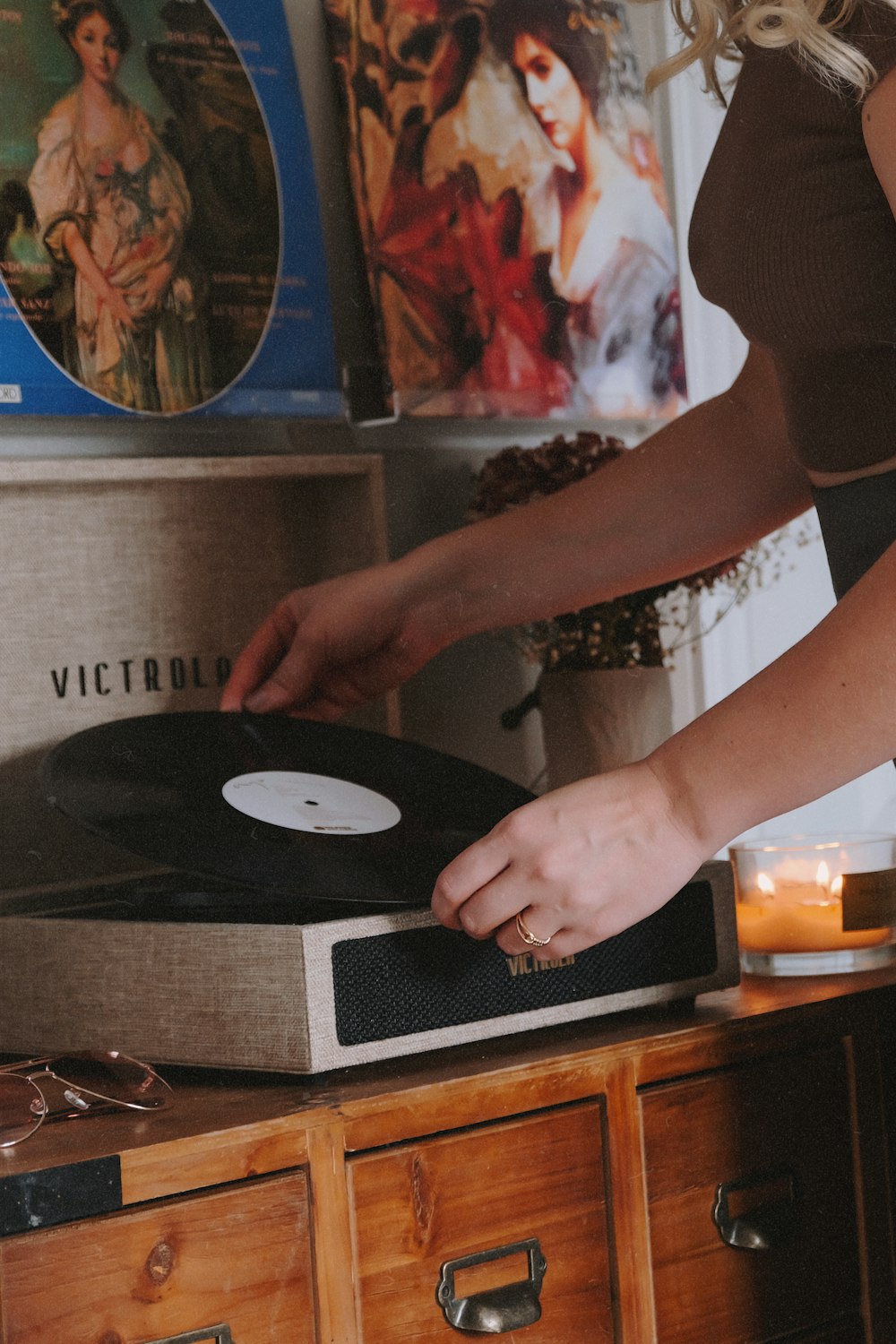 a woman is holding a record in her hand