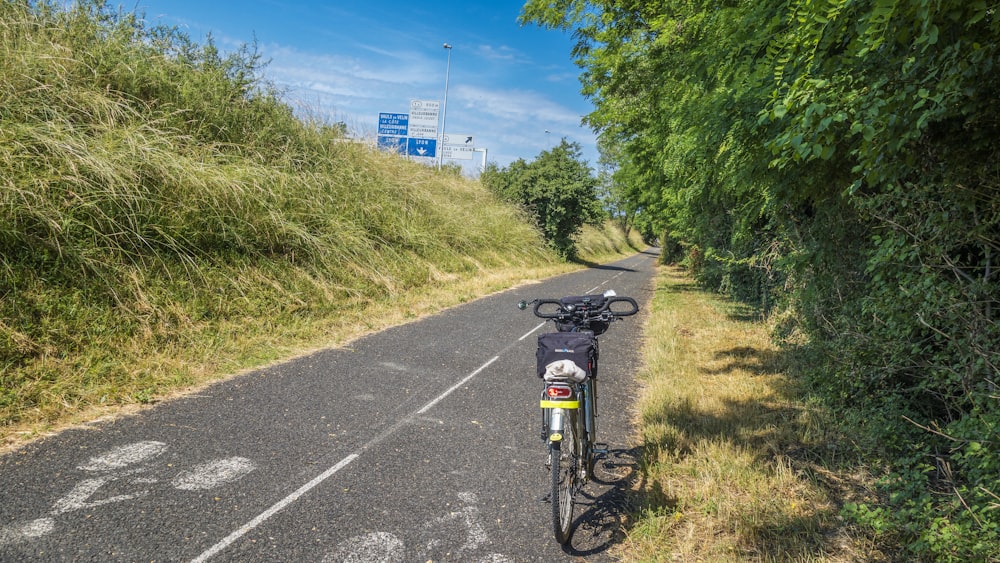 a bicycle parked on the side of a road