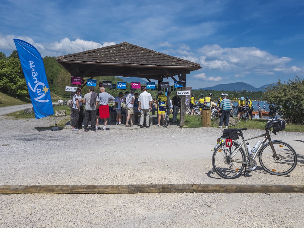 a group of people standing around a bike