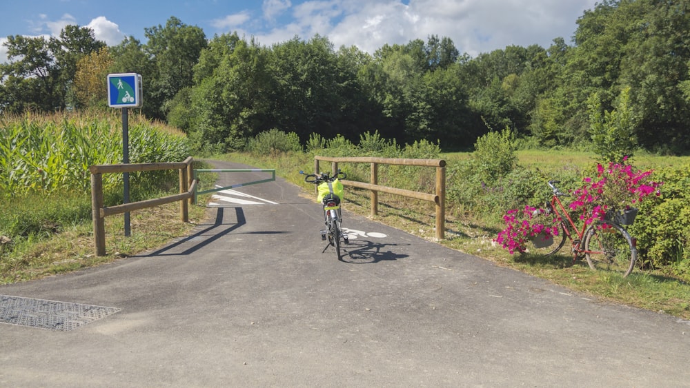 a person riding a bike across a bridge