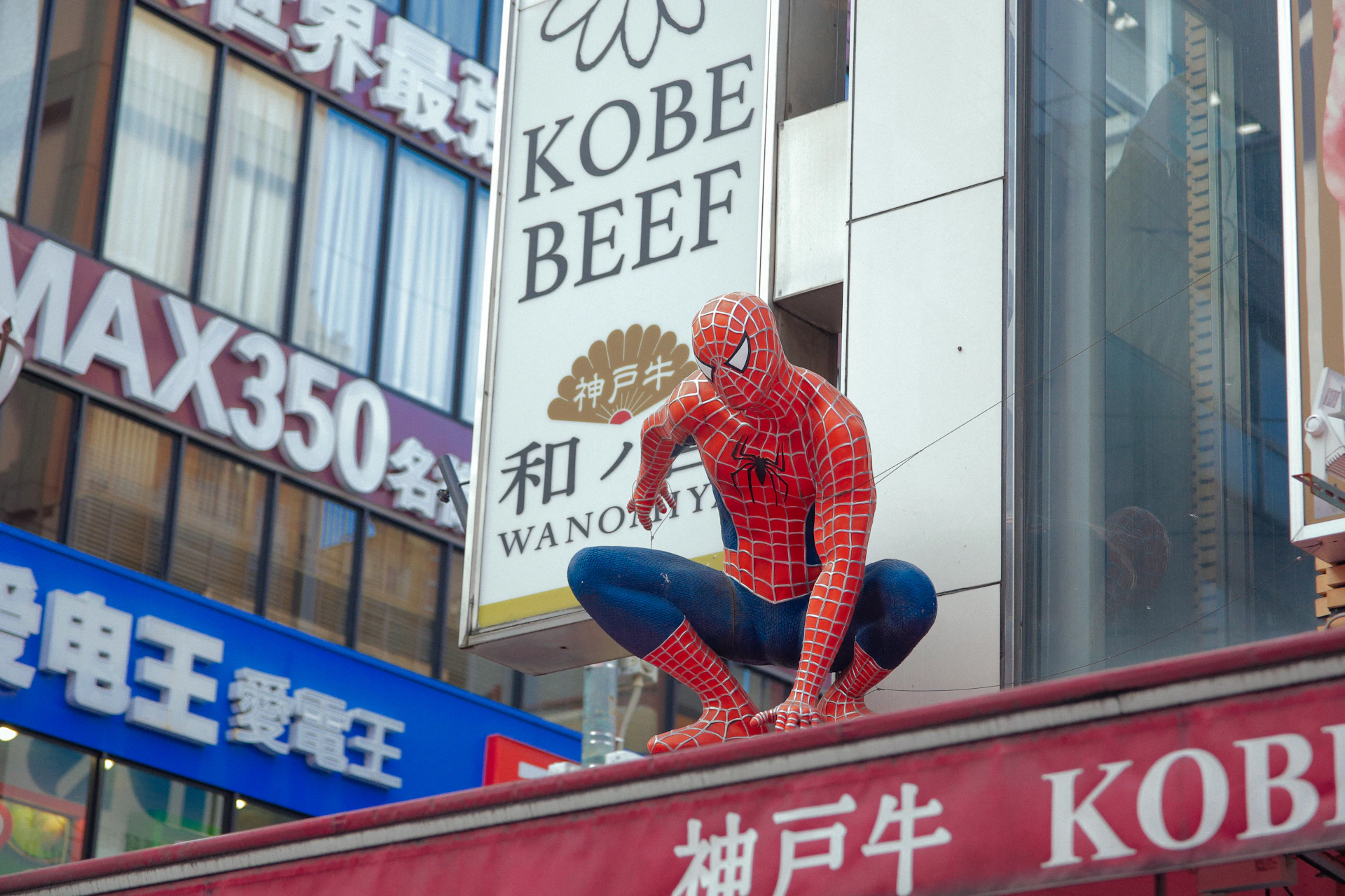 a statue of a spider man on top of a building
