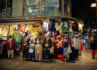 a group of people standing in front of a store