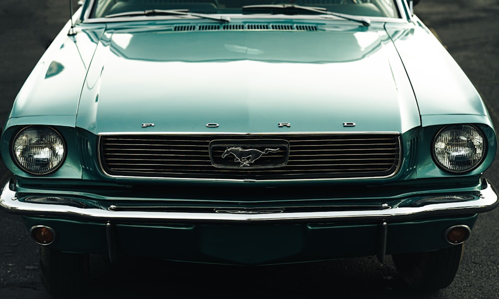 a close up of the front of a green mustang