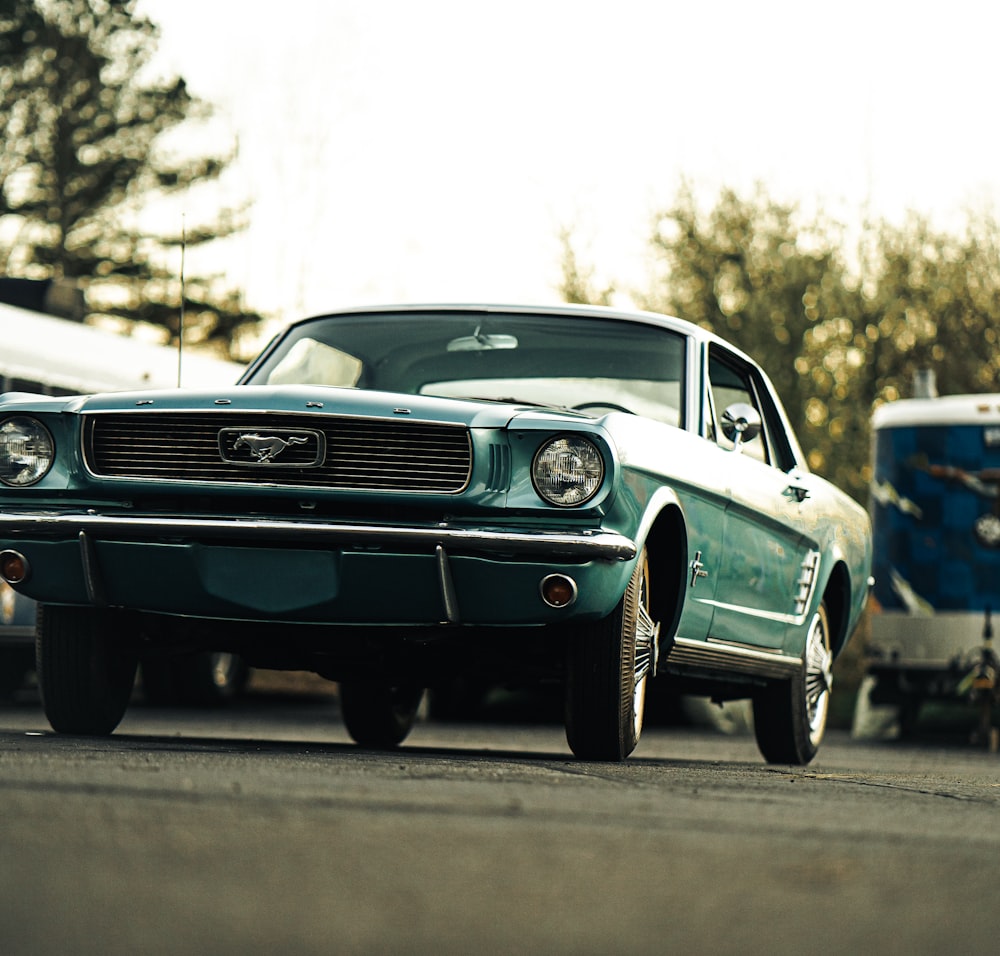 a green mustang parked in a parking lot