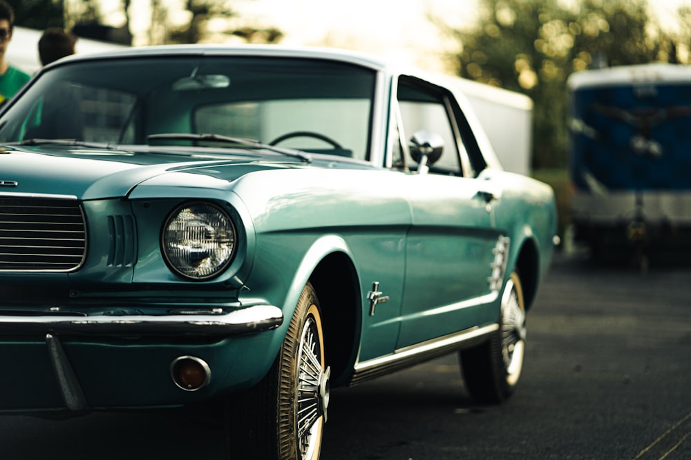 a green mustang parked in a parking lot