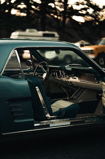 a car with the door open and a steering wheel down