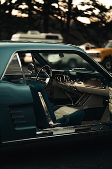 a car with the door open and a steering wheel down