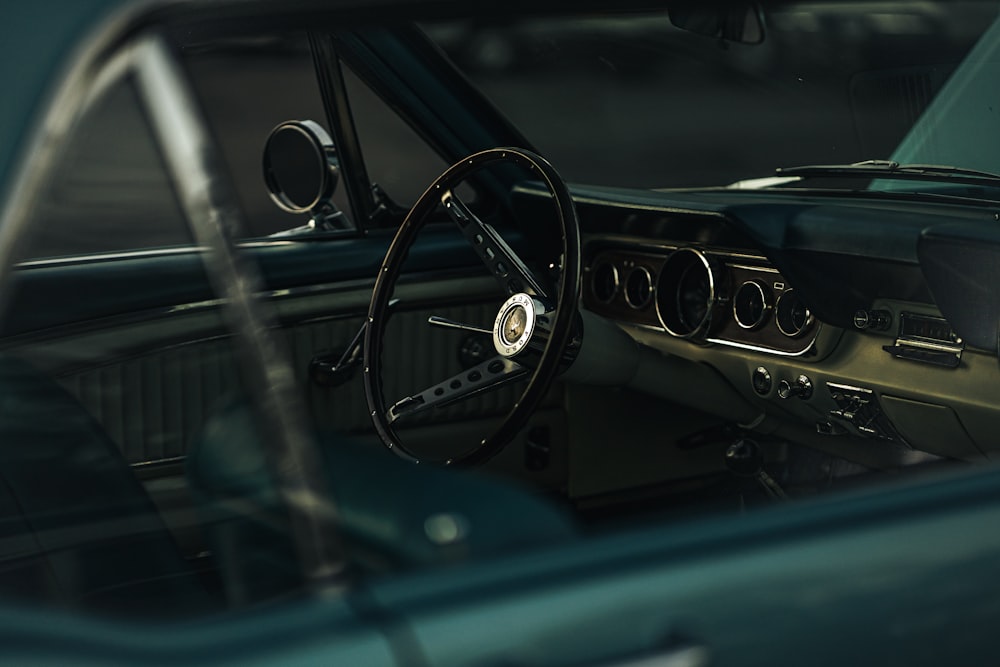 the interior of a car with a steering wheel and dashboard