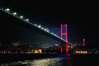 a bridge lit up at night with lights on it