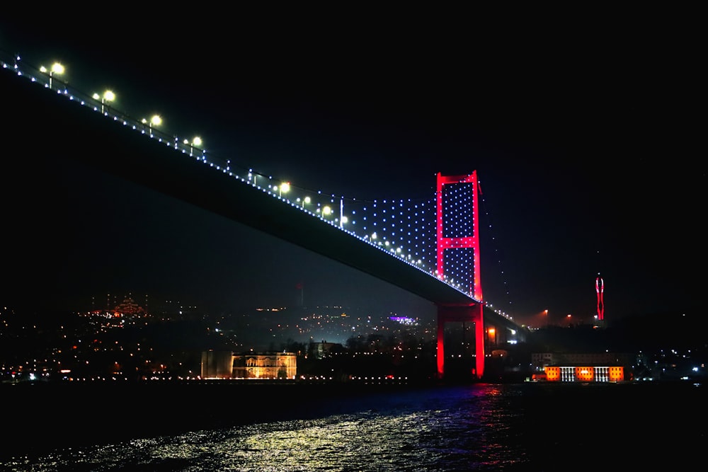 a bridge lit up at night with lights on it