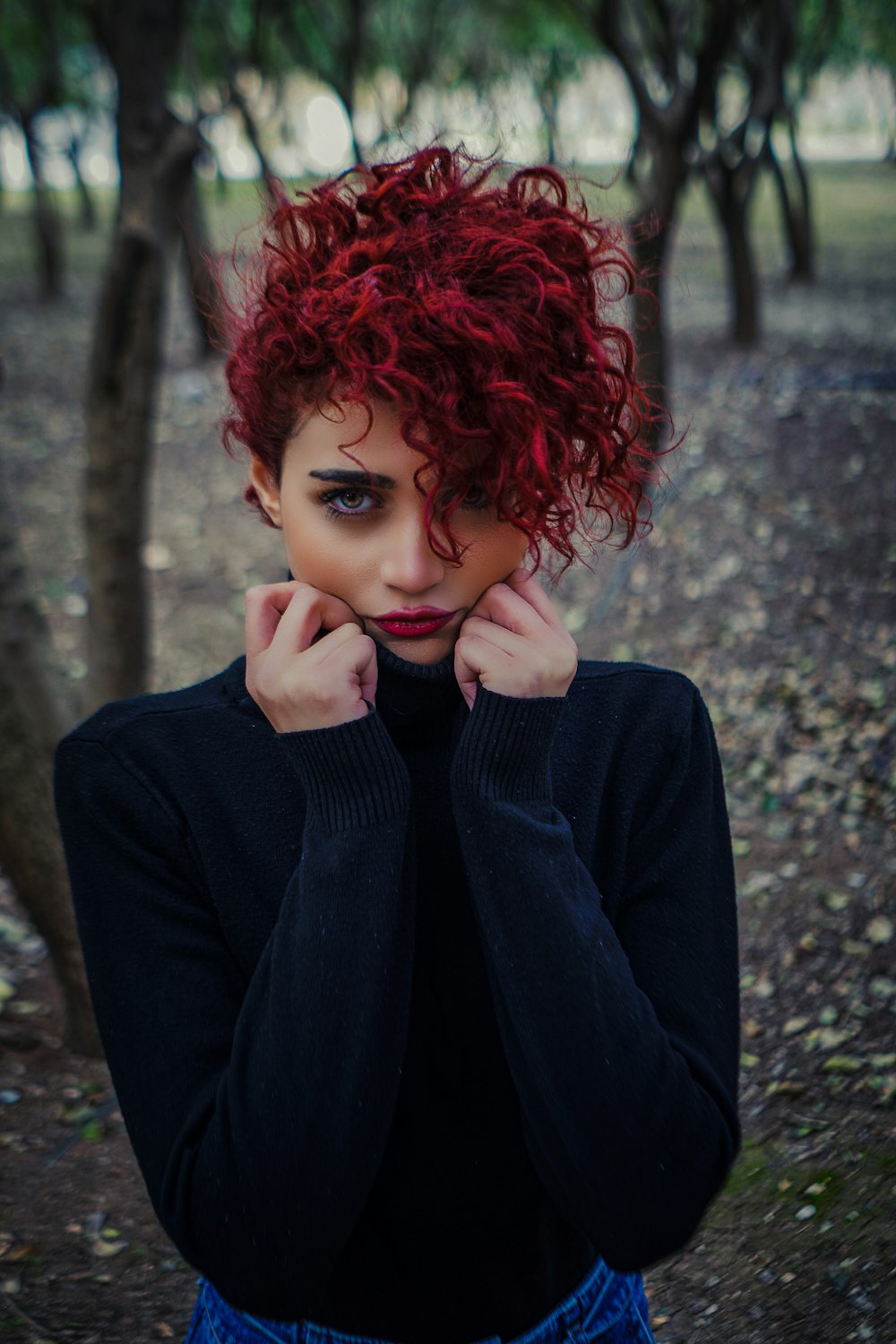 a woman with red hair is posing for a picture