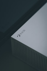 A close-up of a gaming console with various game titles displayed.