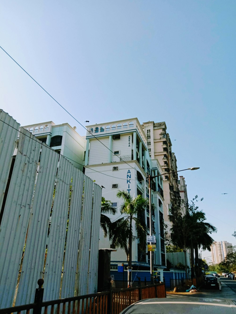 a tall white building sitting next to a street