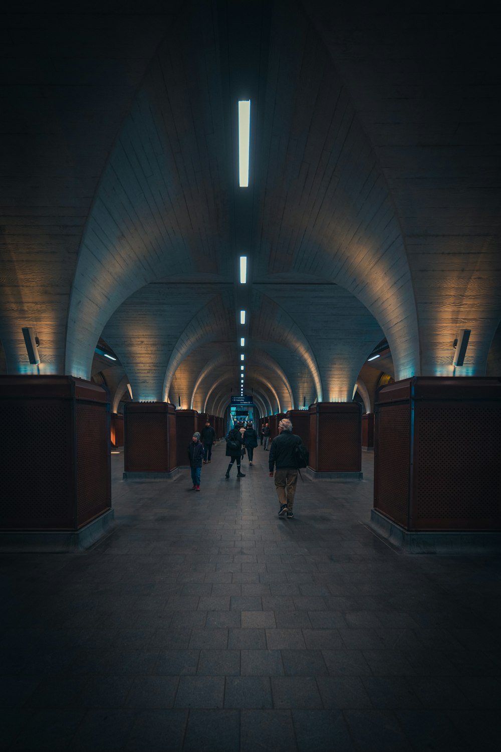 a group of people walking through a tunnel