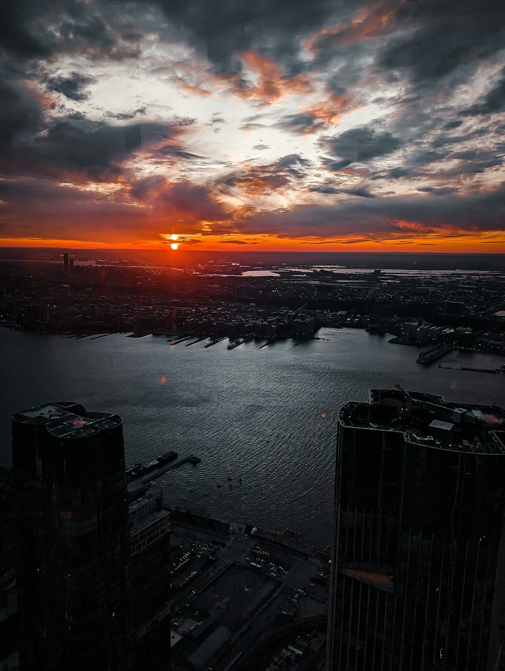 the sun is setting over a large body of water