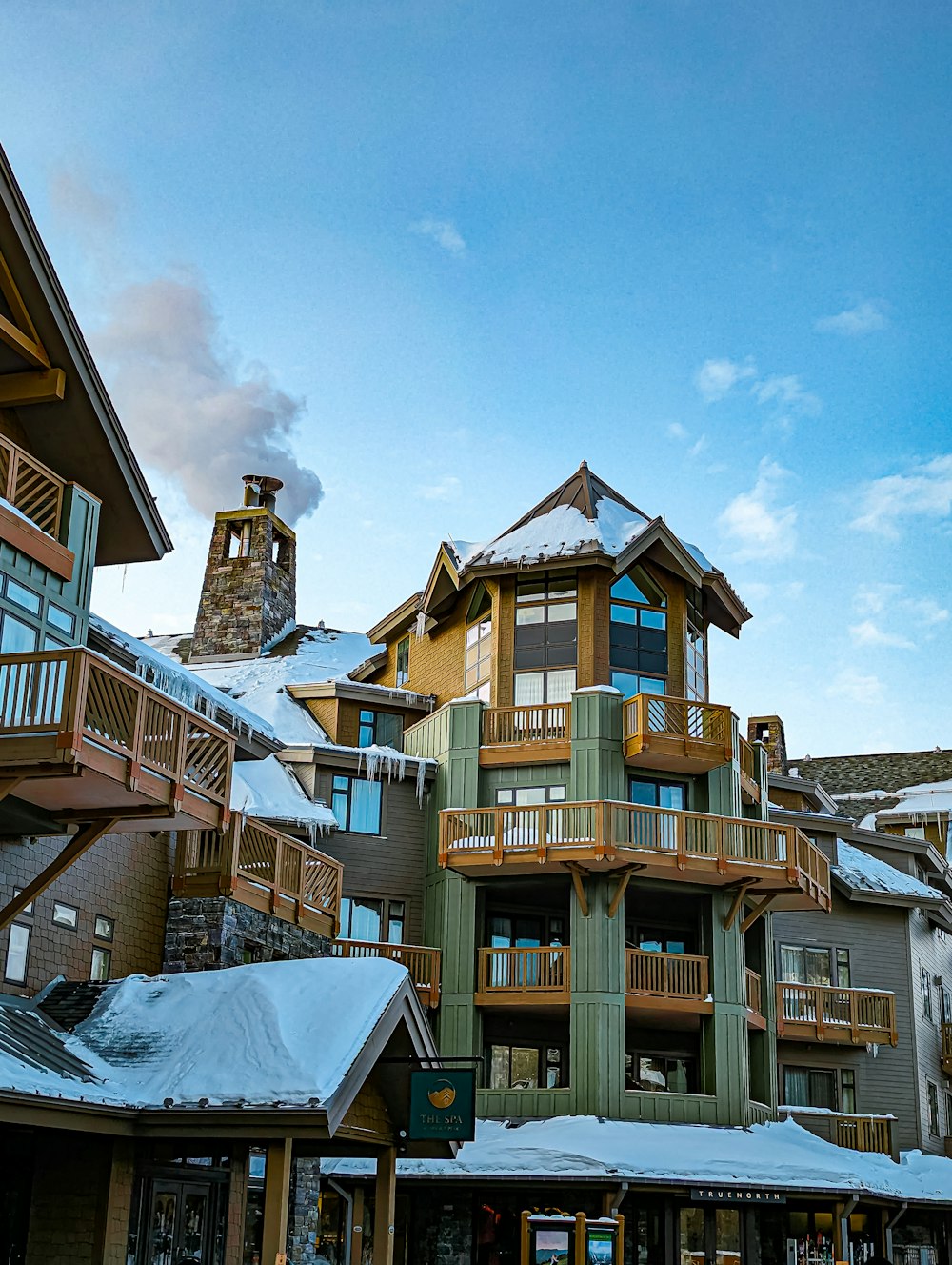 a group of buildings with snow on the ground