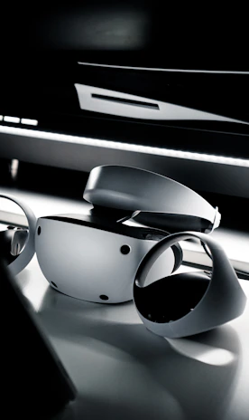 A close-up shot of a VR headset resting on a sleek desk with soft ambient lighting.