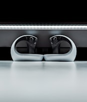 A dynamic photo of wireless gaming controllers placed together on a reflective surface.