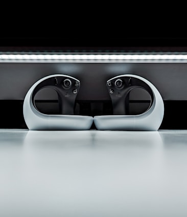 A sleek, futuristic game controller resting on a glowing digital interface background.