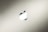A metallic symbol resembling an apple with a bite taken out of it appears centered against a smooth gradient background. The background shifts subtly from light to dark, creating a sleek and modern aesthetic.