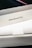 A close-up view of a MacBook Pro box, showcasing the sleek packaging design, primarily in white, with the words 'MacBook Pro' prominently displayed on the side. The image captures the clean lines and minimalistic style typical of Apple product packaging.