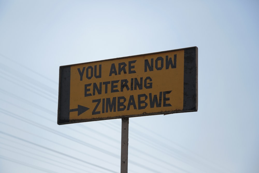 a street sign that says you are now entering zimbawe