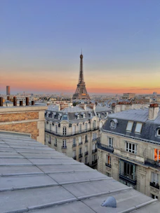 Romantic view of the Eiffel Tower at sunset with soft golden light.