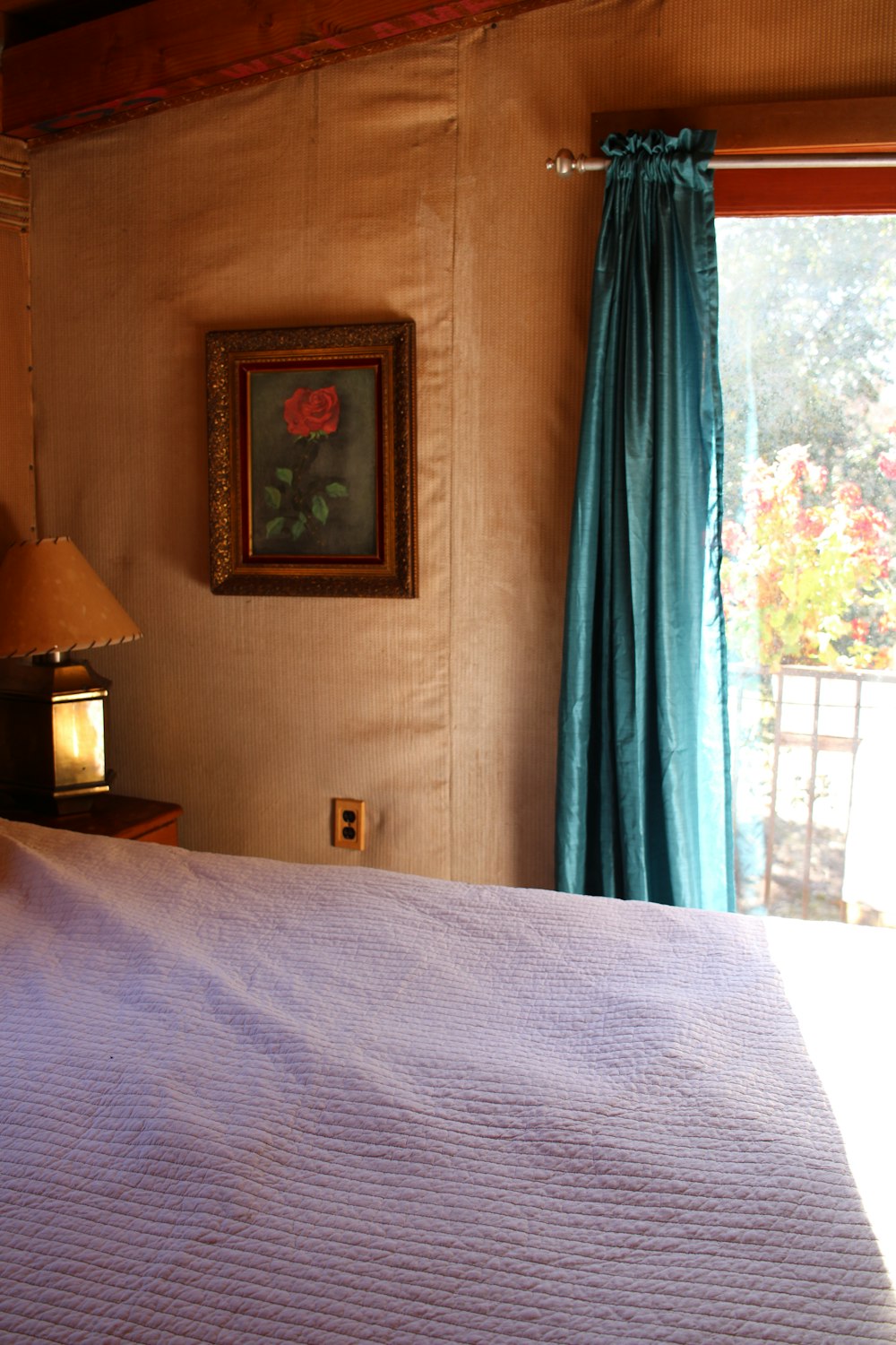 a bedroom with a bed and a painting on the wall