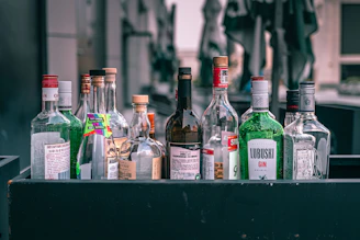 a collection of liquor bottles sitting on top of a table