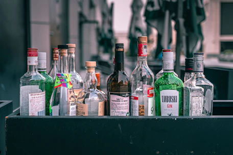 a collection of liquor bottles sitting on top of a table
