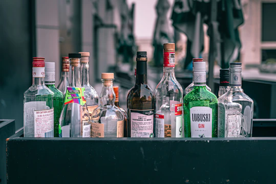 a collection of liquor bottles sitting on top of a table
