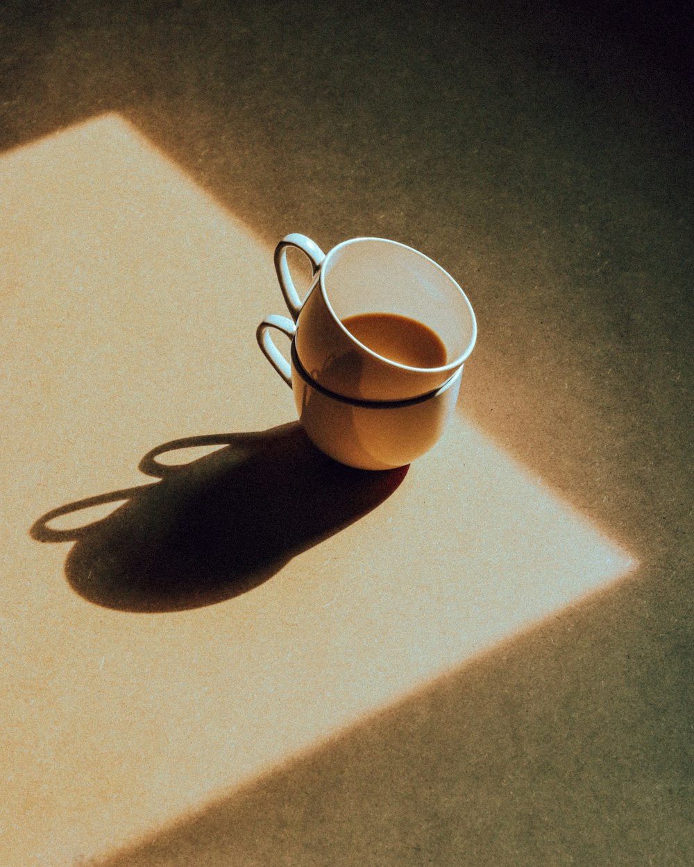 a cup of coffee sitting on top of a table