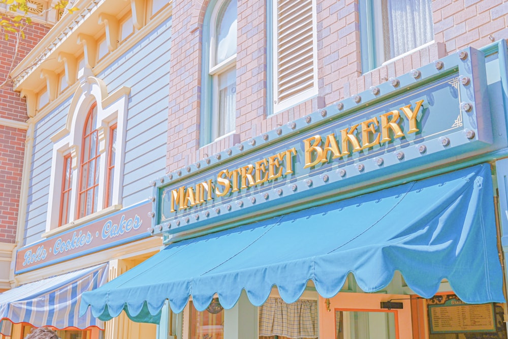 a store front with a blue awning on the outside of it